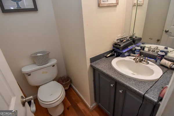 a kitchen with stainless steel appliances a refrigerator a sink a stove a table and chairs