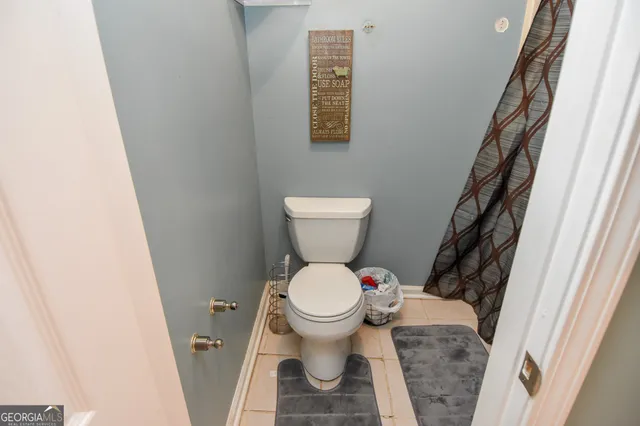 a white toilet sitting next to a small bathroom