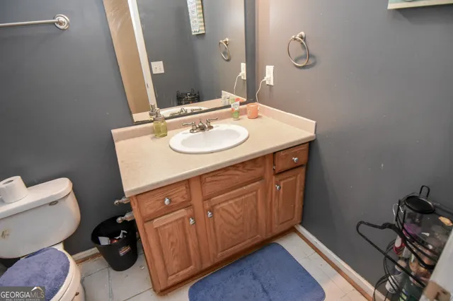 a bathroom with a sink toilet and mirror