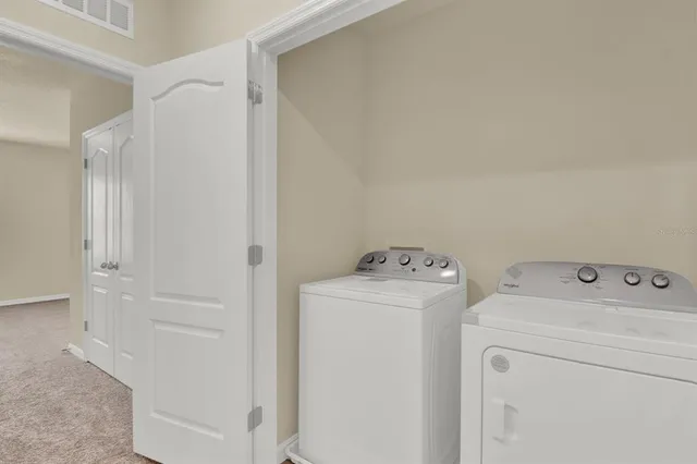 a kitchen with stainless steel appliances granite countertop a sink and a refrigerator