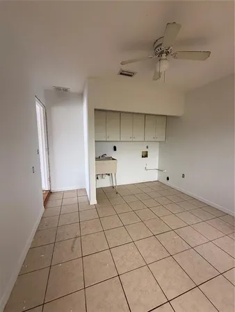 a view of a kitchen with white cabinets