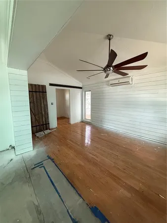 a view of a room with wooden floor