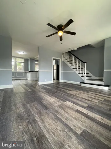 a view of an empty room and wooden floor