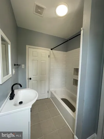 a bathroom with a sink and a shower