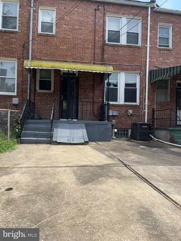 a front view of a building with a garden