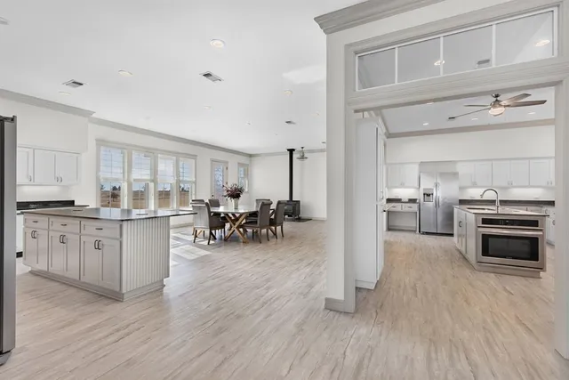 a kitchen with sink cabinets and wooden floor