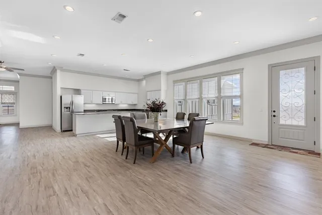 a view of a dining room with furniture and wooden floor
