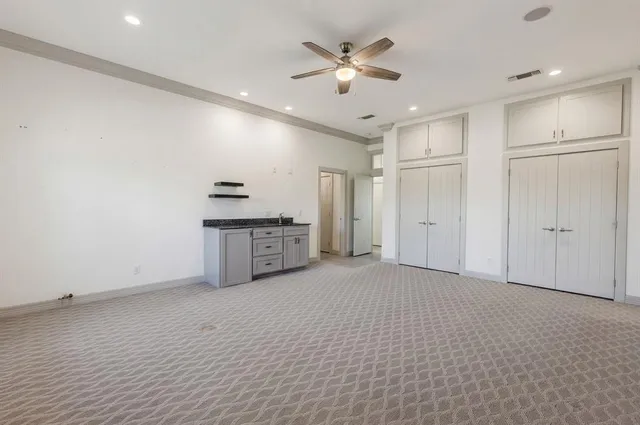 a view of an empty room with a kitchen