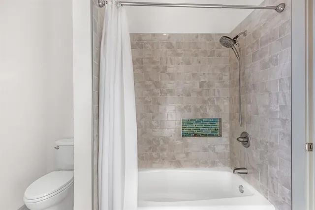 a bathroom with a shower and a bathtub