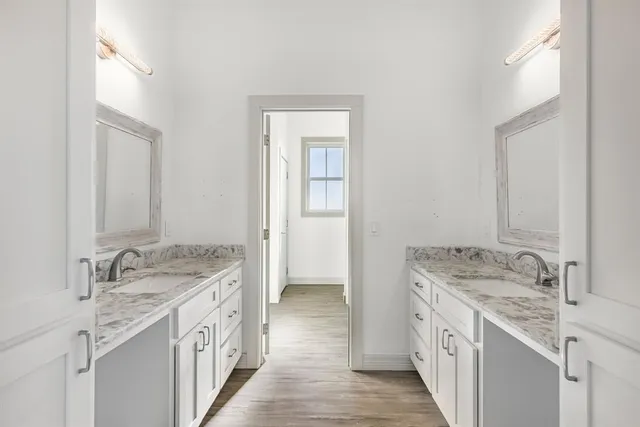 a spacious bathroom with a granite countertop sink and a mirror