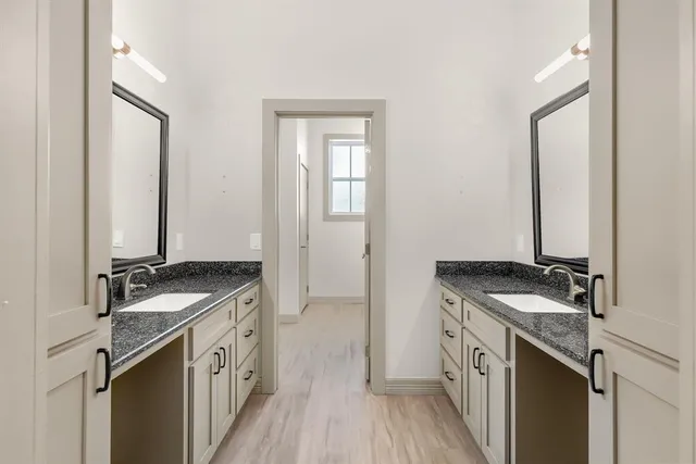 a kitchen with granite countertop a sink stove and cabinets