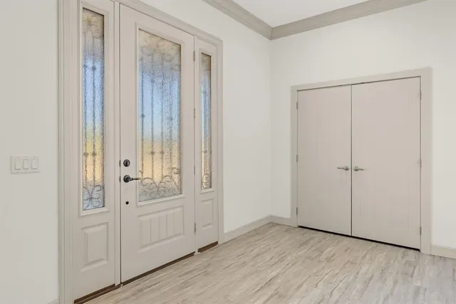 a view of an empty room with wooden floor