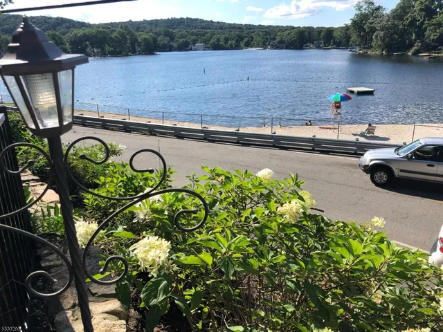a view of a lake with a table and chairs