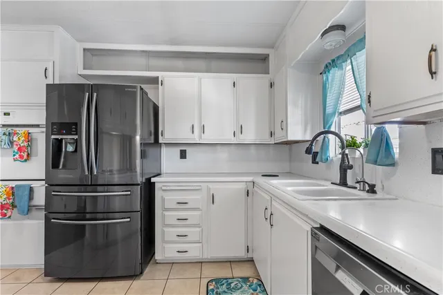 a living room with stainless steel appliances furniture a dining table and chairs with wooden floor