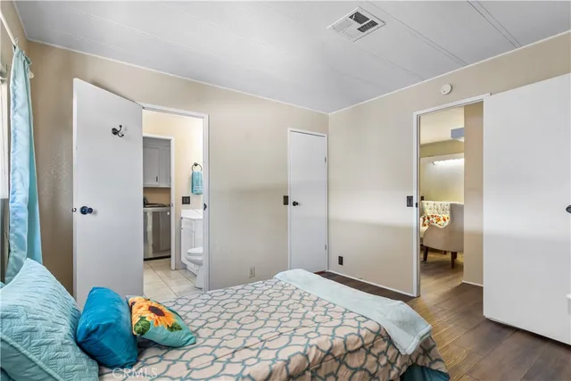 a spacious bathroom with a toilet a sink a mirror and a bathtub