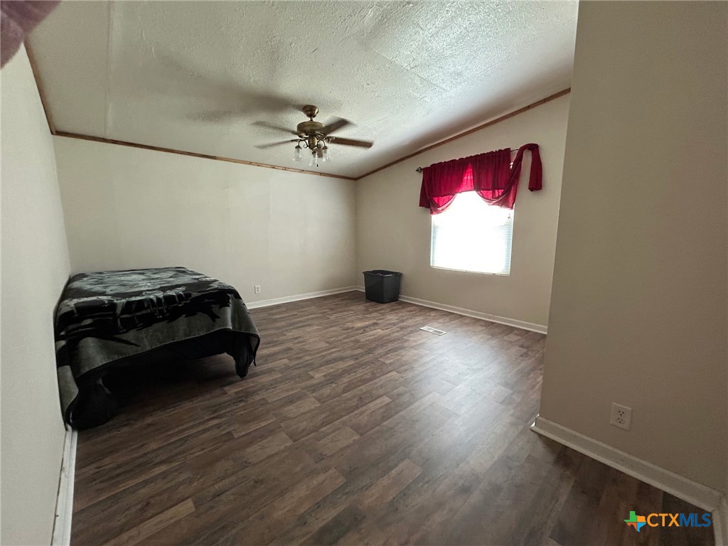 850 Blakely Road Gatesville, TX 76528 - Photo 26 of 32 a view of a room with wooden floor and windows