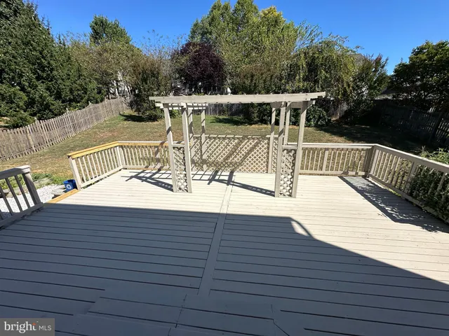 a view of a roof deck with wooden floor and barbeque oven