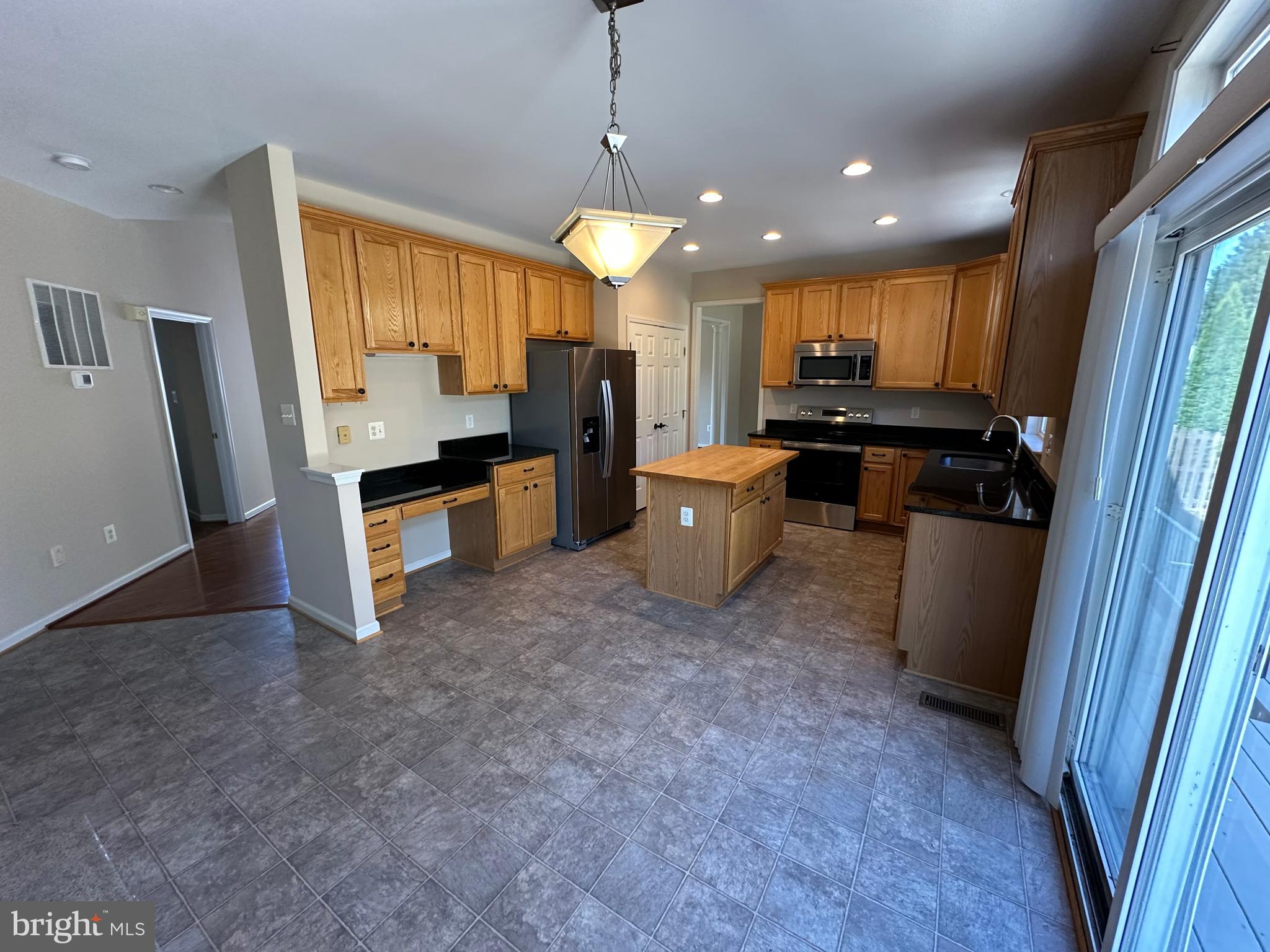 72 Maddex Farm Drive Shepherdstown, WV 25443 - Photo 3 of 20 a open kitchen with stainless steel appliances granite countertop a refrigerator a sink a stove and a refrigerator