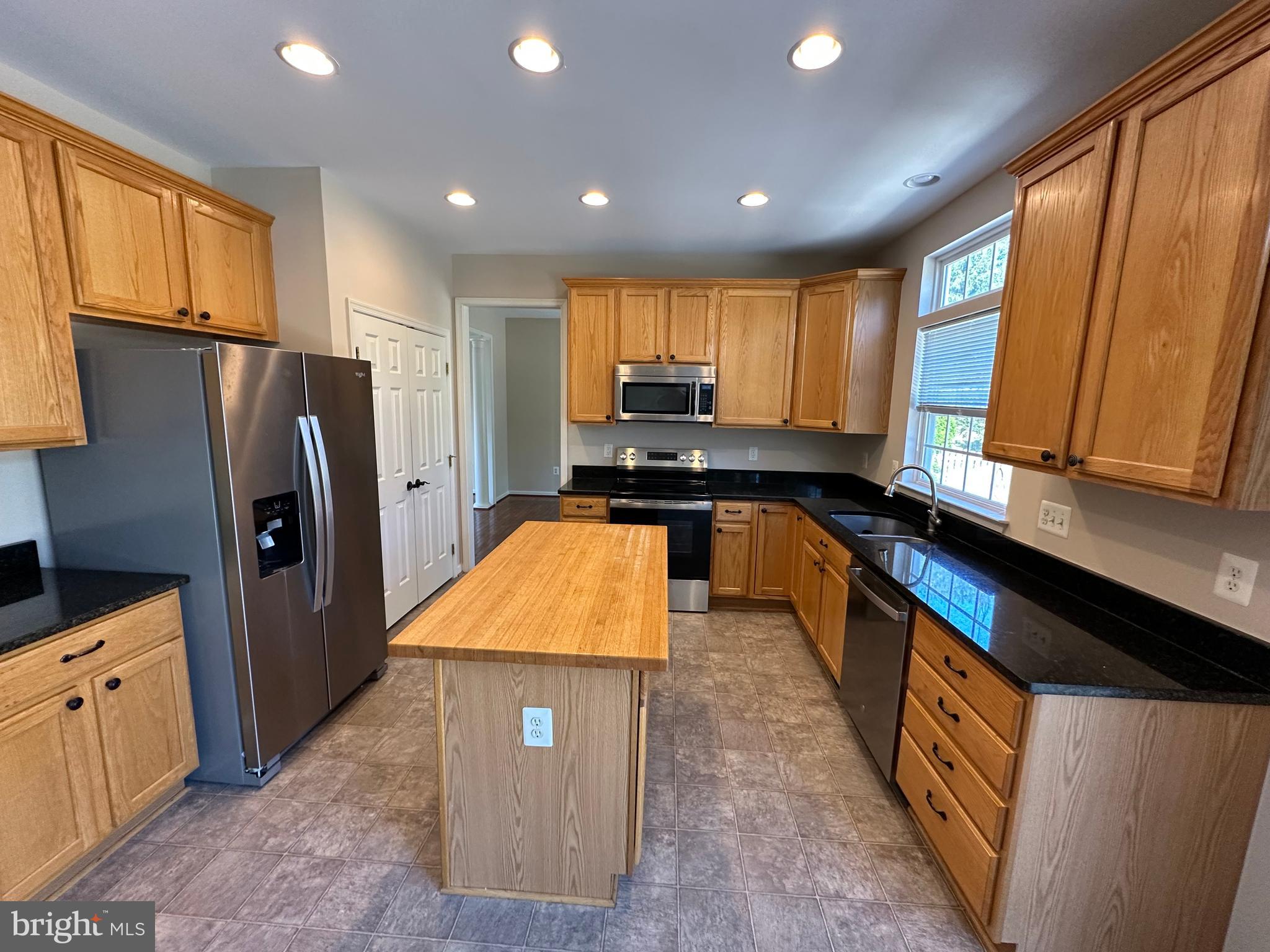 72 Maddex Farm Drive Shepherdstown, WV 25443 - Photo 4 of 20 a kitchen with stainless steel appliances granite countertop a refrigerator a stove and a sink