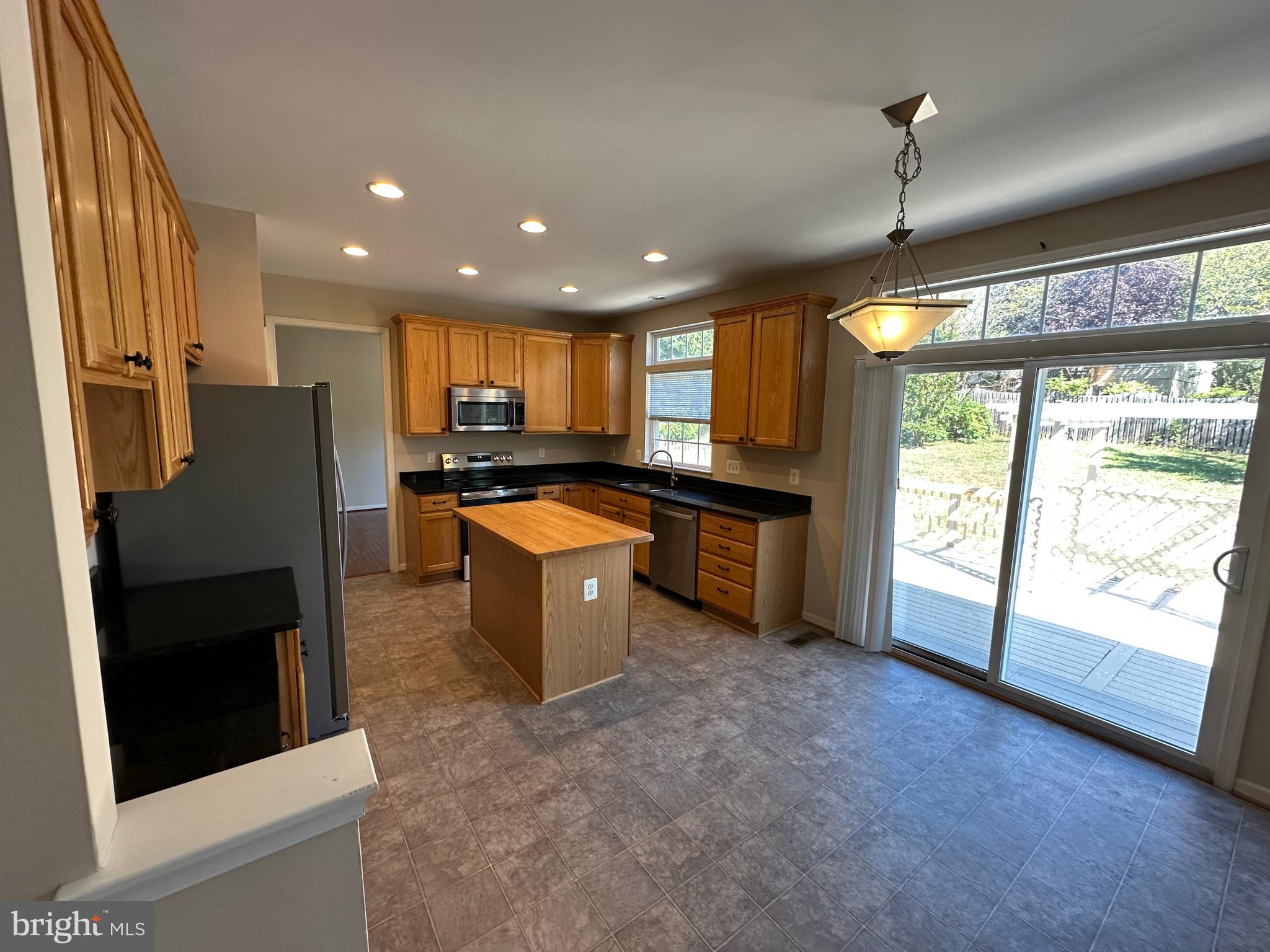 72 Maddex Farm Drive Shepherdstown, WV 25443 - Photo 5 of 20 a kitchen with stainless steel appliances granite countertop sink refrigerator and window