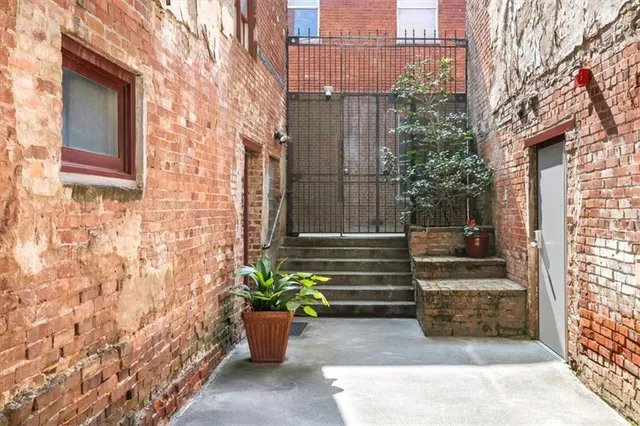 a view of a patio with chairs and potted plants