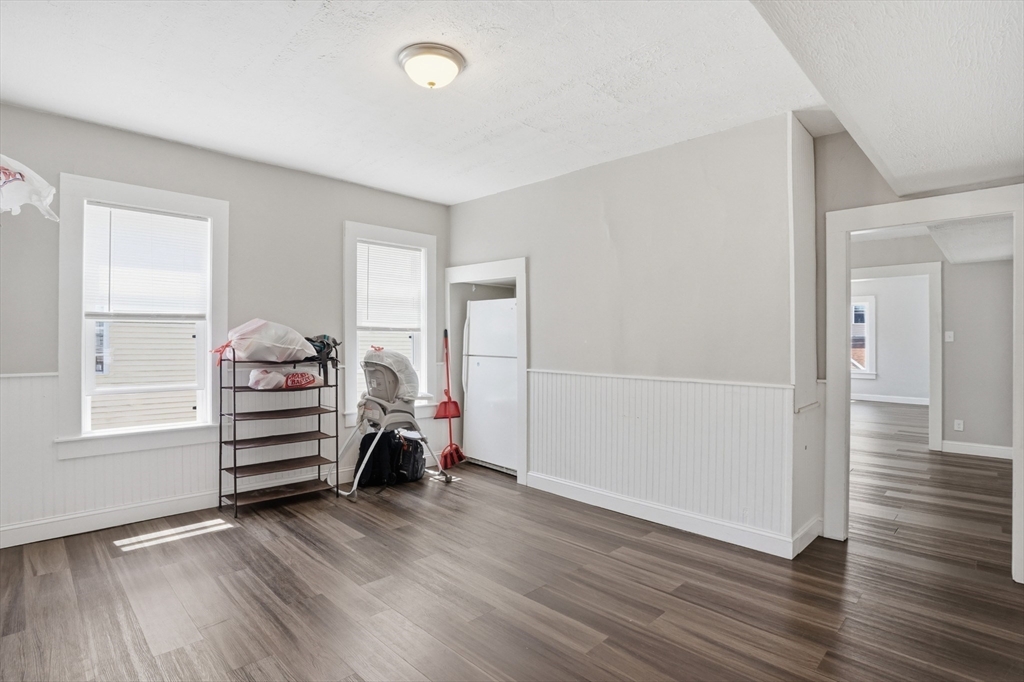 196 Irving Street Fall River, MA 02723 - Photo 9 of 34 wooden floor in an empty room with a window