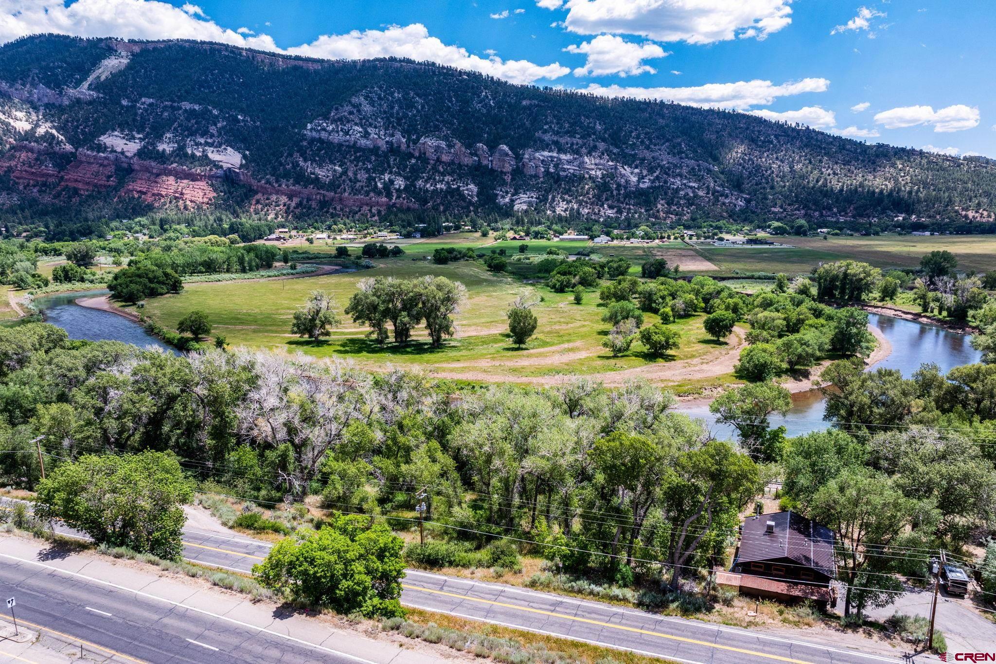 1110 Animas View Drive Durango, CO 81301 - Photo 6 of 32 a view of a lake with a mountain and trees in the background