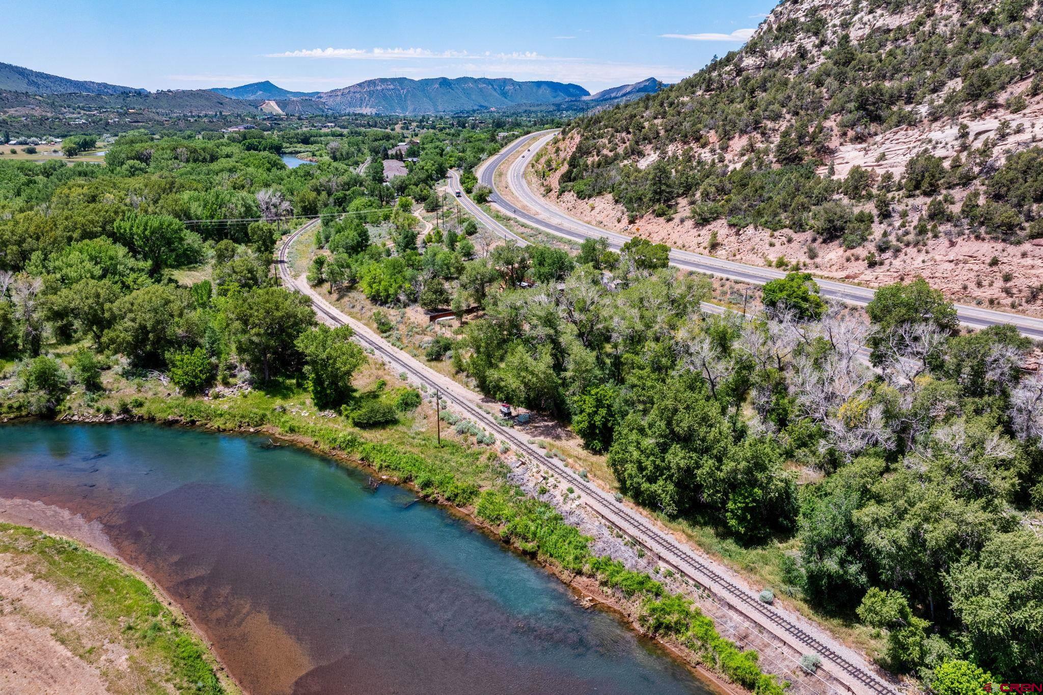 1110 Animas View Drive Durango, CO 81301 - Photo 8 of 32 an aerial view of a house with a yard and lake view