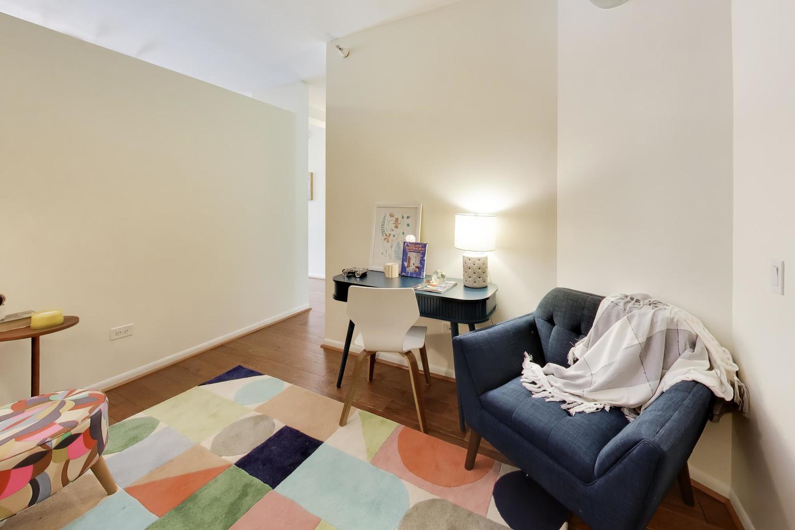 1200 West Monroe Street, Unit 502 Chicago, IL 60607 - Photo 19 of 34 a living room with a couch and a dining table with wooden floor