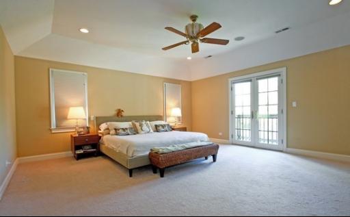 2360 Greenview Road Northbrook, IL 60062 - Photo 8 of 12 a bedroom with a bed a window and a chandelier