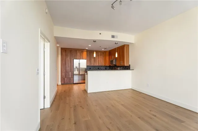 a view of a kitchen with a sink and a refrigerator