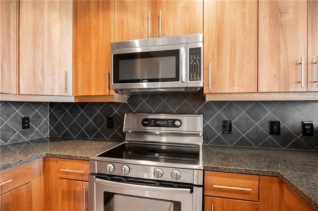 a stove top oven sitting inside of a kitchen