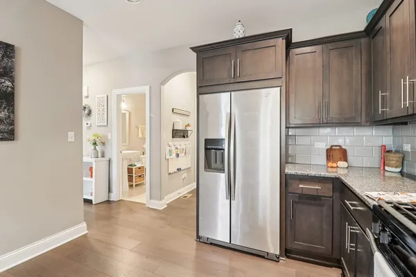 a kitchen with stainless steel appliances granite countertop a refrigerator and a sink