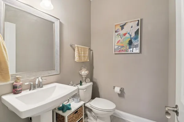 a bathroom with a toilet a sink and mirror