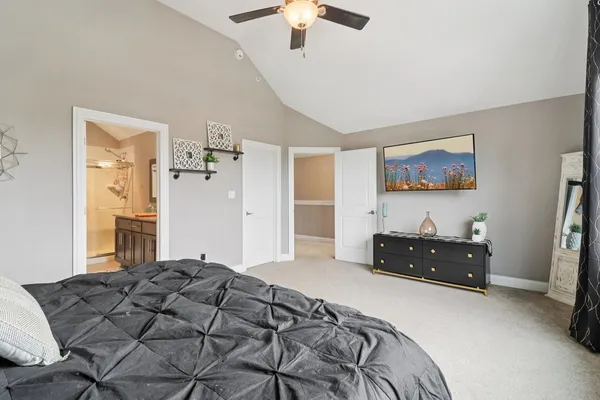 a bedroom with a bed and a chandelier