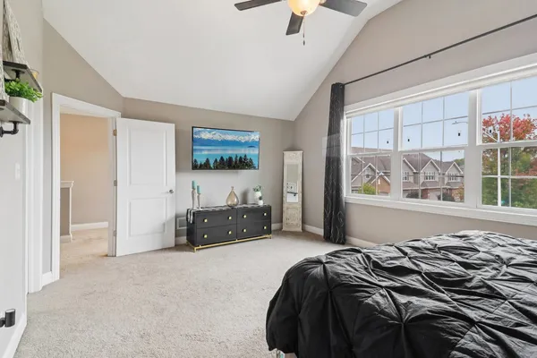 a bed sitting in a bedroom next to a window