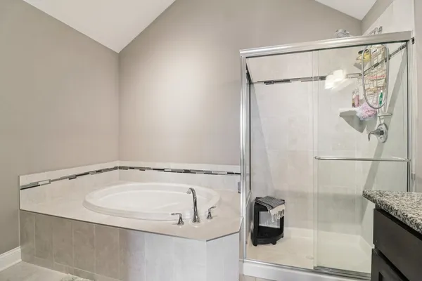 a bathroom with a shower and a tub