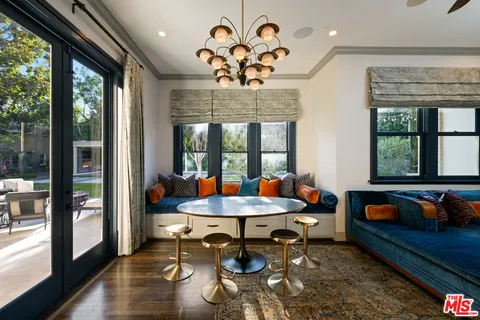 a outdoor room with furniture and a large window