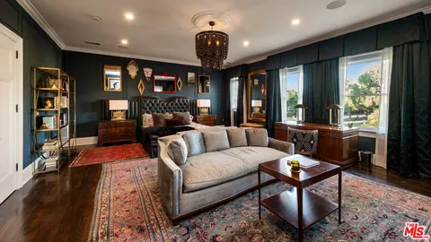 a living room with furniture a rug and a large window
