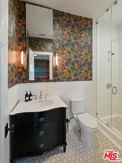 a bathroom with a sink toilet and shower
