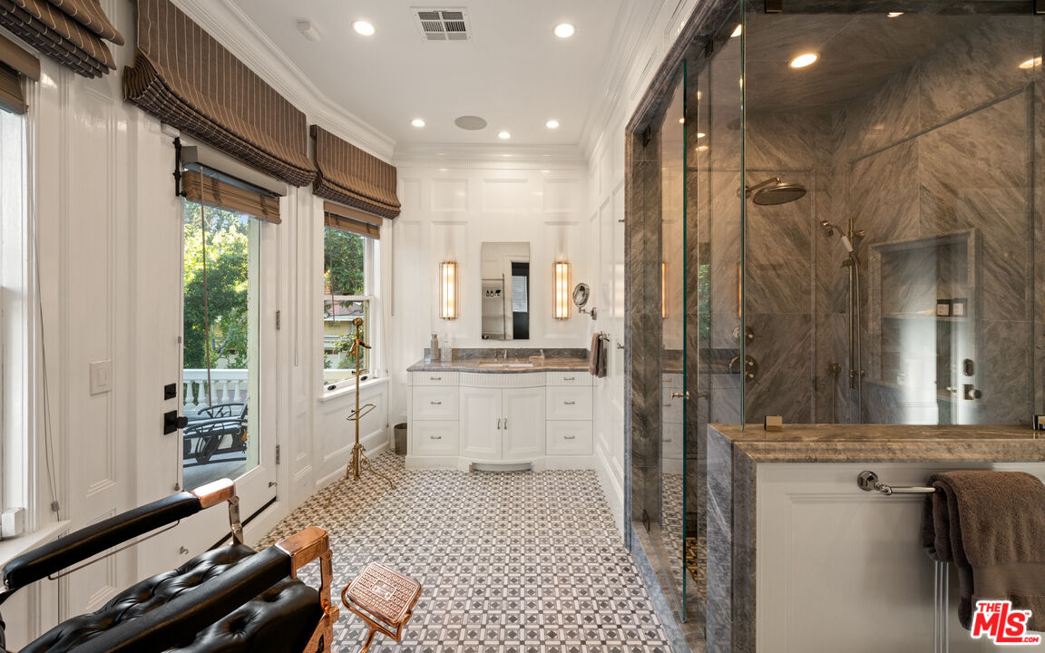 601 South Windsor Boulevard Los Angeles, CA 90005 - Photo 28 of 48 a bathroom with a double vanity sink a mirror and a shower