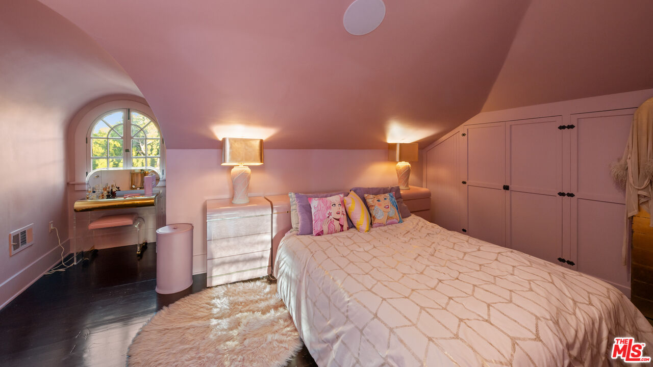 601 South Windsor Boulevard Los Angeles, CA 90005 - Photo 37 of 48 a bedroom with a bed and a chandelier