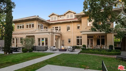 a front view of a house with a garden and plants