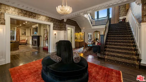 a lobby with furniture chandelier and living room
