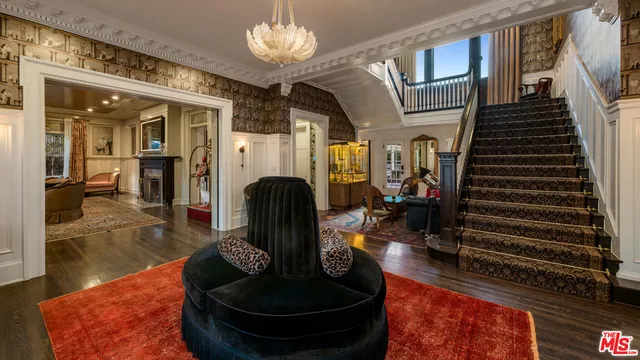 a lobby with furniture chandelier and living room