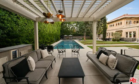 a view of a patio with couches chairs and a yard