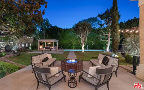 a view of swimming pool with outdoor seating