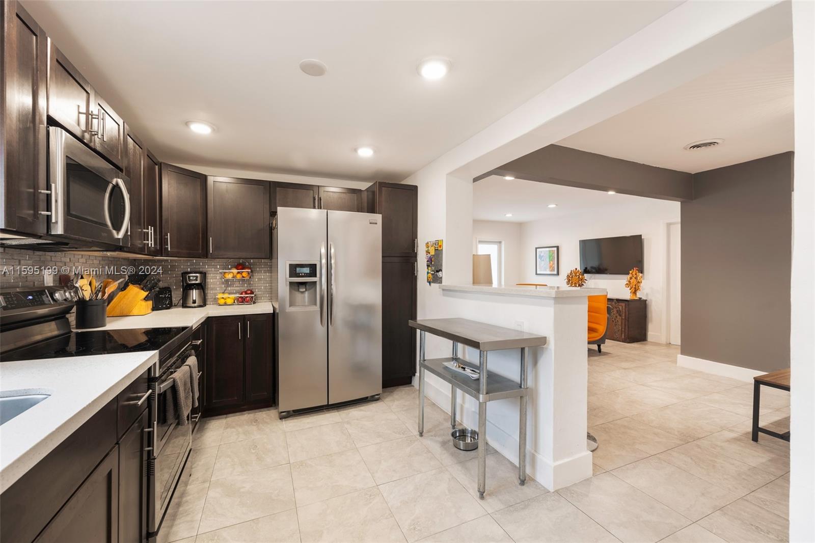 4420 Northwest 3rd Avenue Miami, FL 33127 - Photo 11 of 36 a kitchen with stainless steel appliances granite countertop a refrigerator and a sink