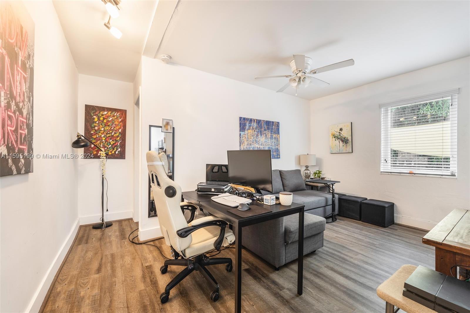 4420 Northwest 3rd Avenue Miami, FL 33127 - Photo 13 of 36 a workspace with furniture and a wooden floor