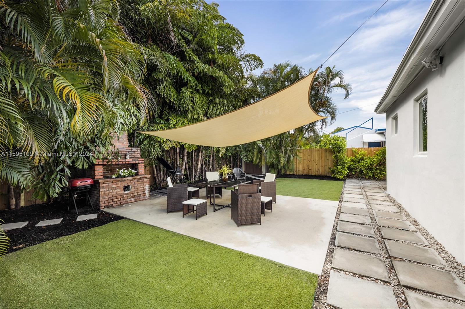 4420 Northwest 3rd Avenue Miami, FL 33127 - Photo 27 of 36 a view of a patio with table and chairs potted plants and a palm tree